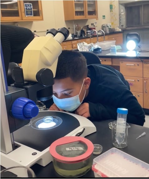 Micro w student leaning in